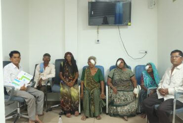 Shivam Charitable Trust healthcare team with villagers during the Mega Health Camp Sujana Muvada for diabetes, BP, and eye check-up services.