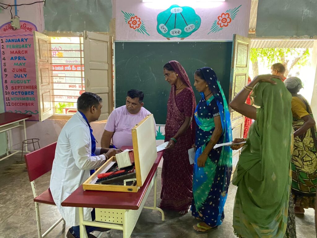 Mega Health Camp Sujana Muvada organized by Shivam Charitable Trust for free diabetes, BP, and eye check-up services in rural villages.