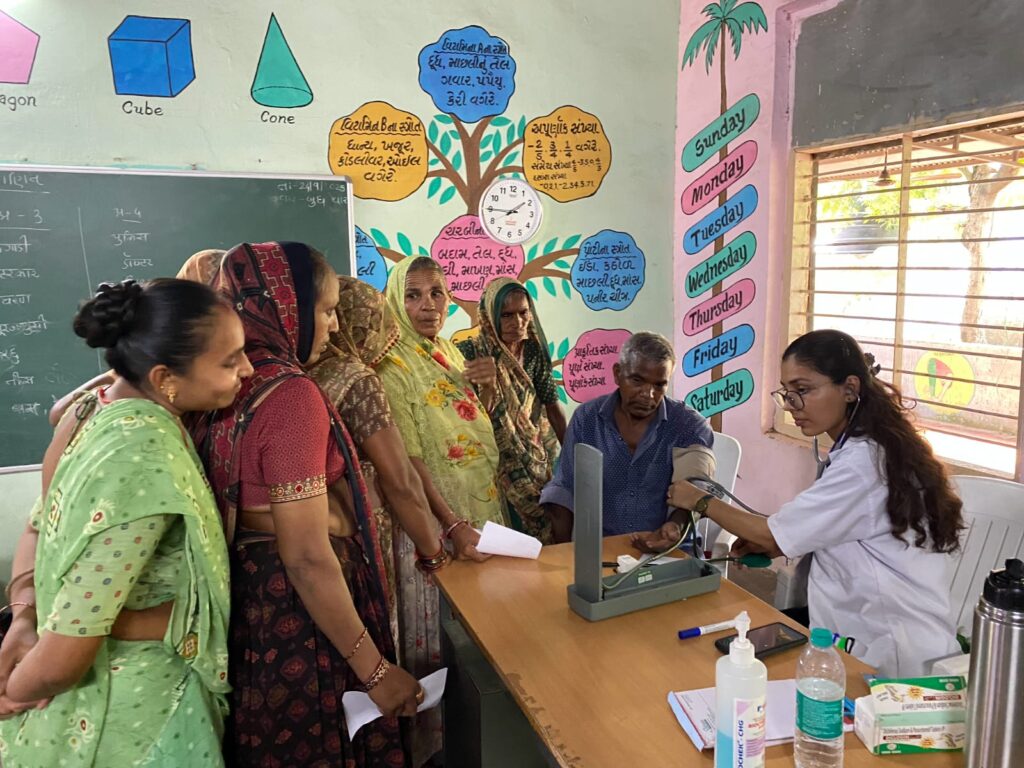 Mega Health Camp Sujana Muvada organized by Shivam Charitable Trust for free diabetes, BP, and eye check-up services in rural villages.