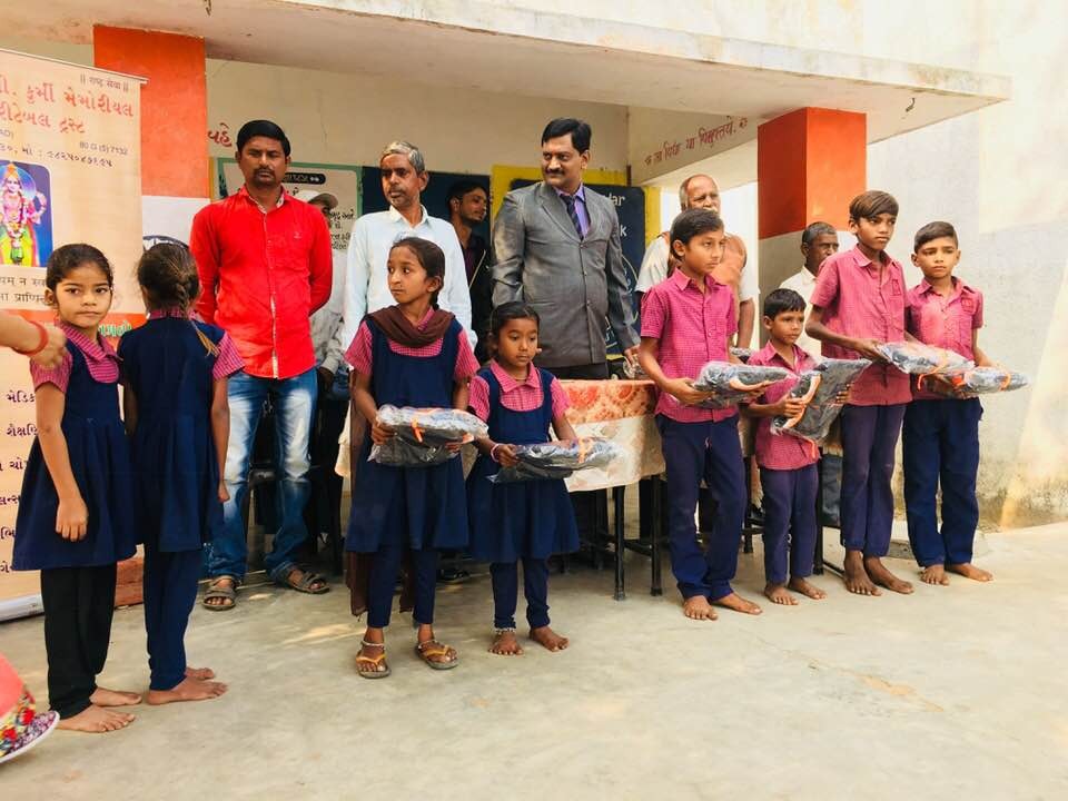 Shivam Charitable Trust distributing school bags, books, and educational kits to underprivileged children in Gujarat.Education Support for Underprivileged Children