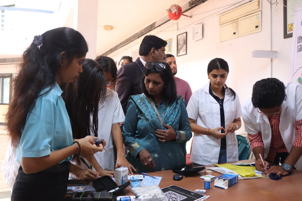 Medical volunteers conducting diabetes screening and patient registration during a DEFEAT DIABETESE health camp.