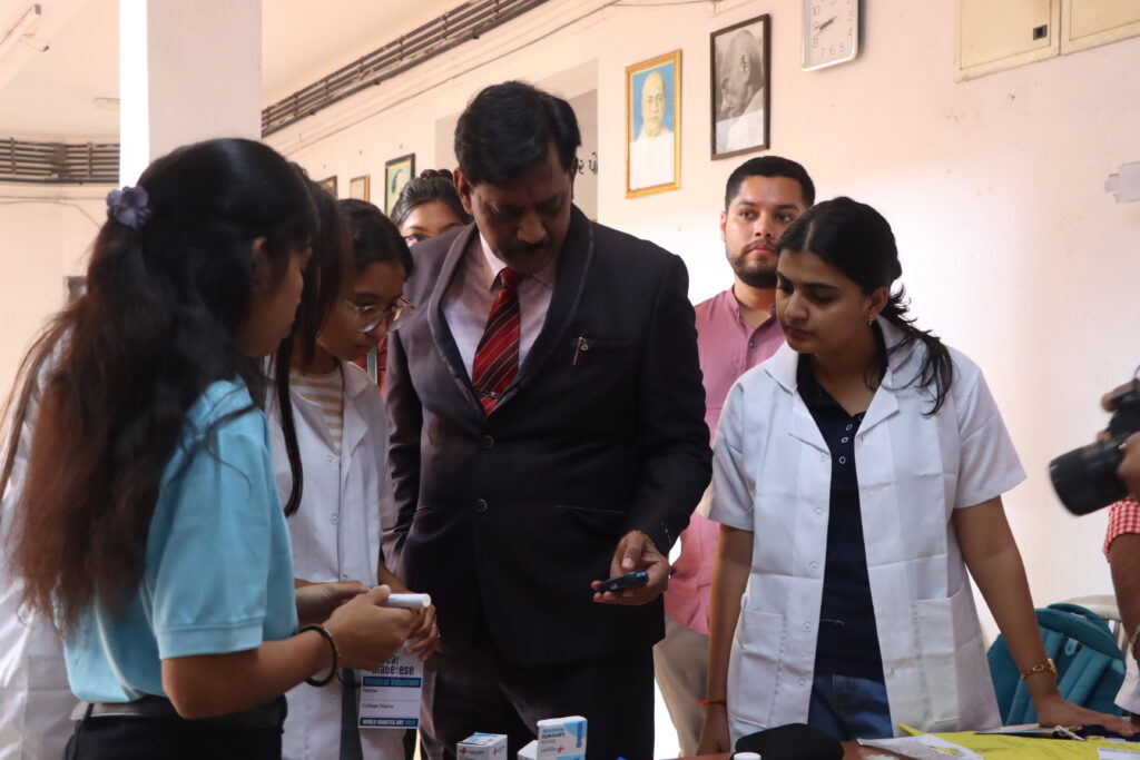 Medical volunteers conducting diabetes screening and patient registration during a DEFEAT DIABETESE health camp.