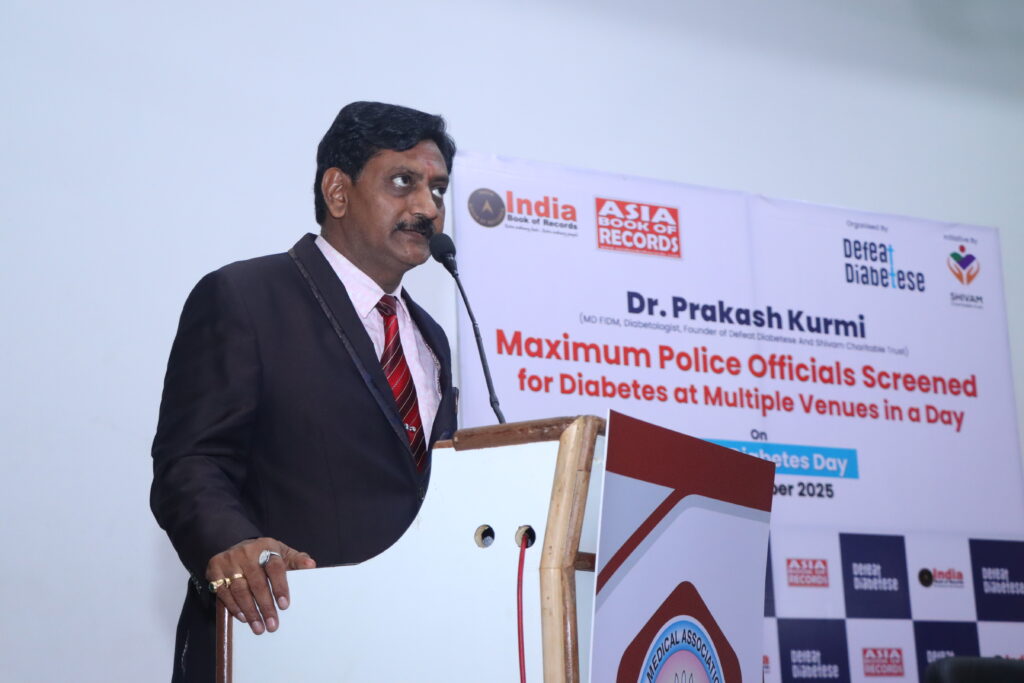 Dr. Prakash Kurmi addressing an audience during a healthcare awareness event organized by Shivam Charitable Trust and DEFEAT DIABETESE.