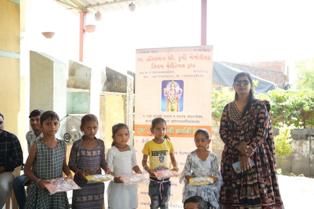 Shivam Charitable Trust distributing school bags, books, and educational kits to underprivileged children in Gujarat.Education Support for Underprivileged Children