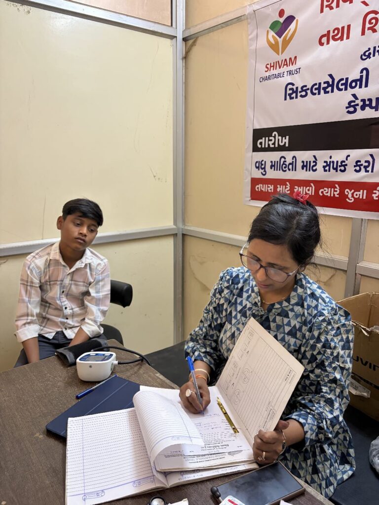 Sickle Cell patient receiving medical consultation and treatment support during a Shivam Charitable Trust health camp in Dahod.