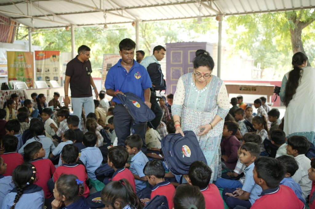 Shivam Charitable Trust and Rasna distribute approximately 450 bags in Patan, Gujarat, as part of a community welfare initiative.