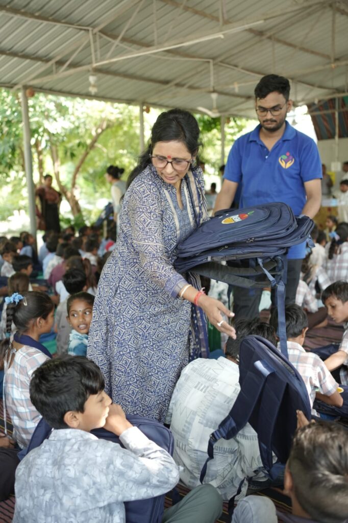 Shivam Charitable Trust and Rasna distribute approximately 450 bags in Patan, Gujarat, as part of a community welfare initiative.