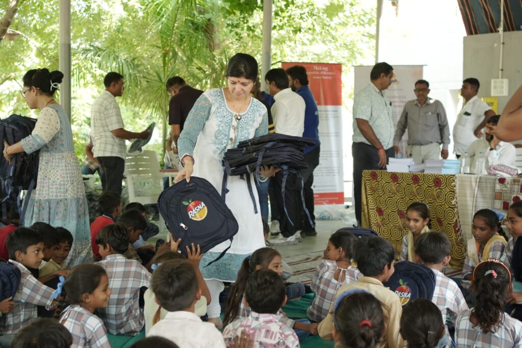Shivam Charitable Trust and Rasna distribute approximately 450 bags in Patan, Gujarat, as part of a community welfare initiative.