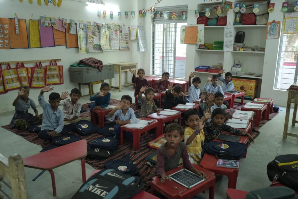 Shivam Charitable Trust and Rasna distribute approximately 450 bags in Patan, Gujarat, as part of a community welfare initiative.