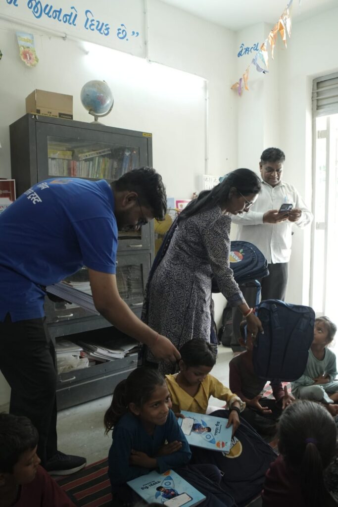 Shivam Charitable Trust and Rasna distribute approximately 450 bags in Patan, Gujarat, as part of a community welfare initiative.