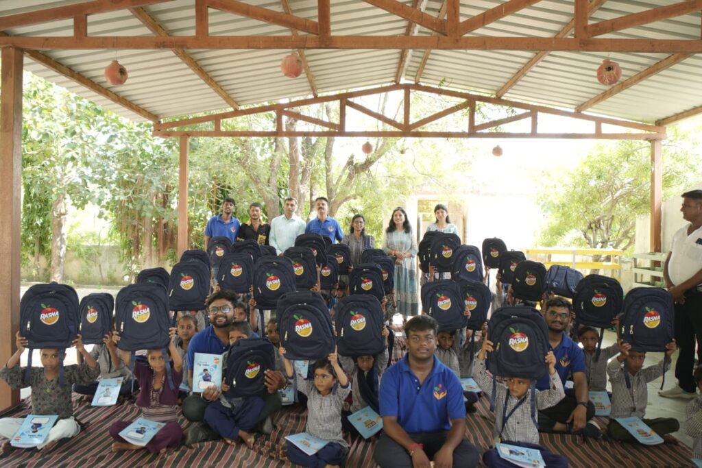 Shivam Charitable Trust and Rasna distribute approximately 450 bags in Patan, Gujarat, as part of a community welfare initiative.