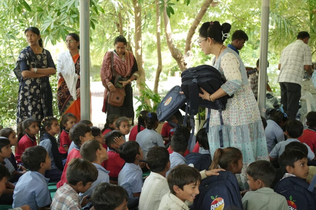 Shivam Charitable Trust and Rasna distribute approximately 450 bags in Patan, Gujarat, as part of a community welfare initiative.
